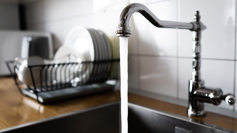 Kitchen sink with water flowing out of it