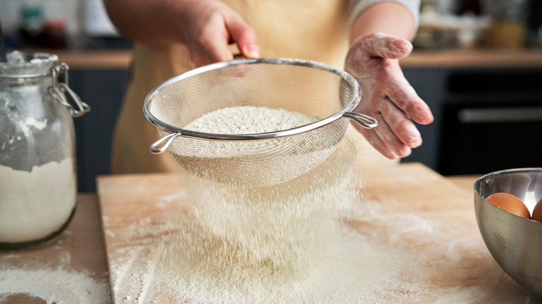 Sifting flour in a home kitchen 