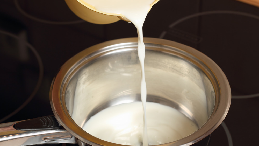 Poring heavy cream in pot