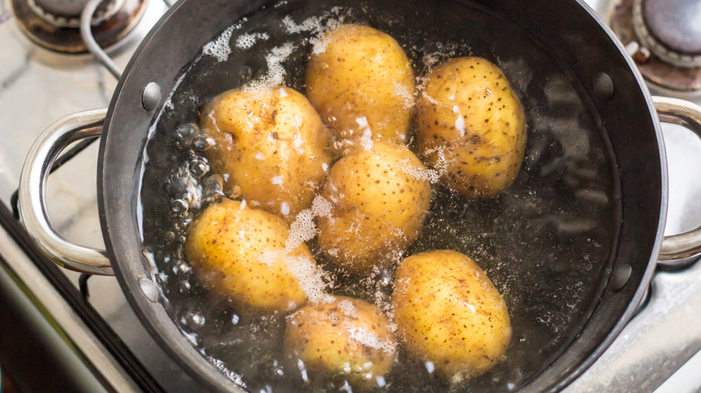 Potatoes boiling in pot