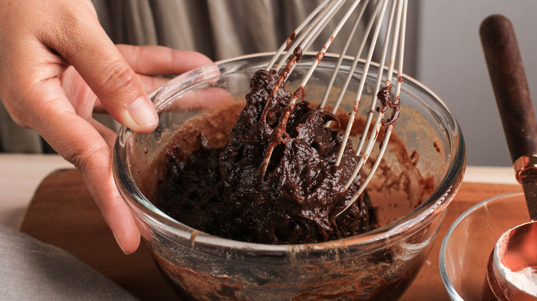 whisking a bowl of brownie batter