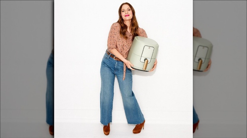 Drew Barrymore holds her air fryer