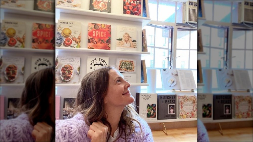 Drew Barrymore in front of some of her cookbooks