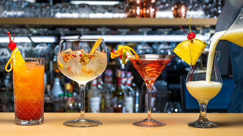 assorted colorful cocktails on a bar