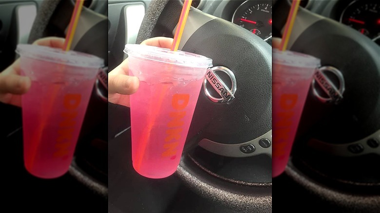 Dunkin' pink drink in car