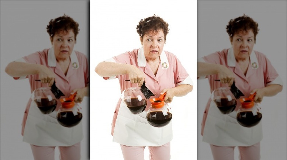 Nervous diner waitress pouring coffee