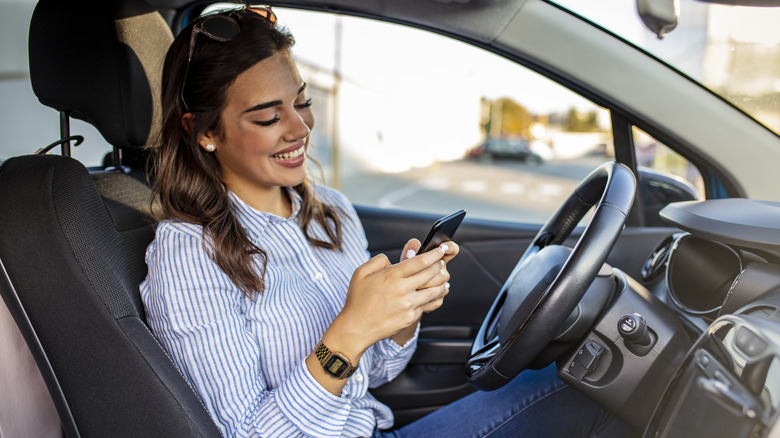 Distracted woman texting while driving