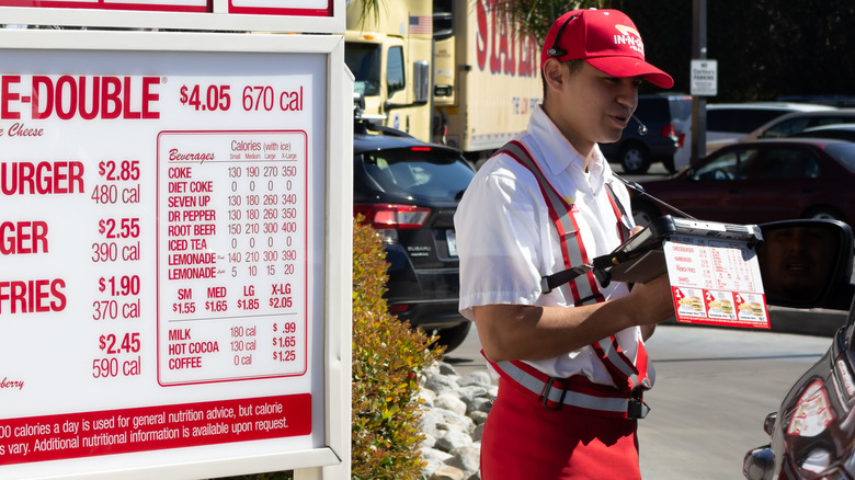 Worker taking order at drive-thru