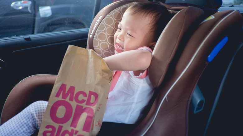 Child with hand in McDonald's bag