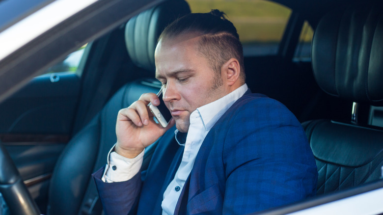 Man talking on phone in car
