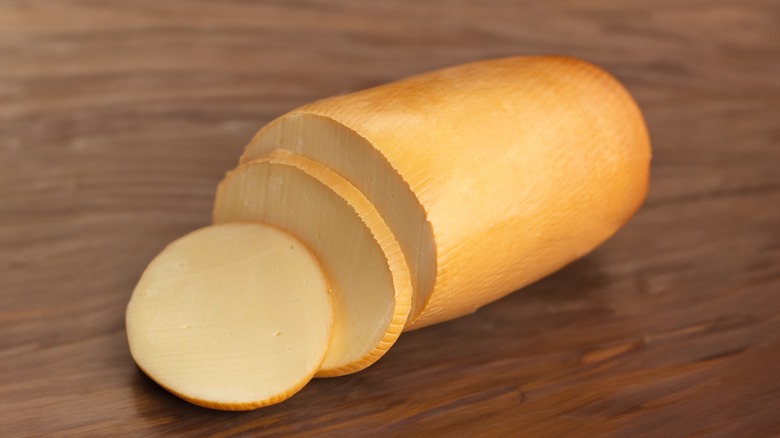 Provolone cheese on wooden board