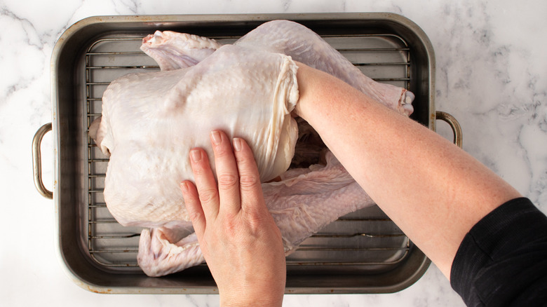 hands removing turkey cavity