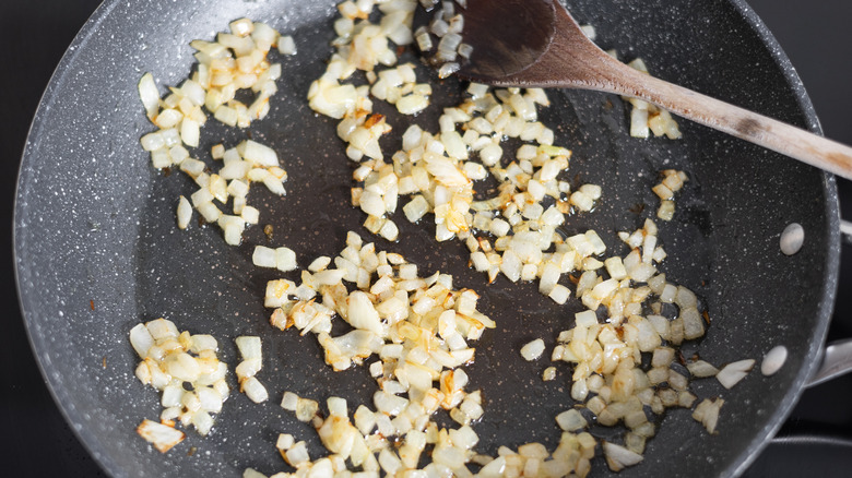 sauteeing diced onions in skillet