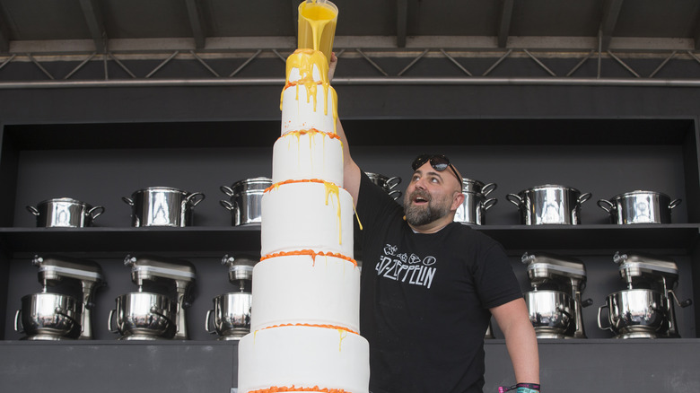 Duff Goldman decorating a huge cake