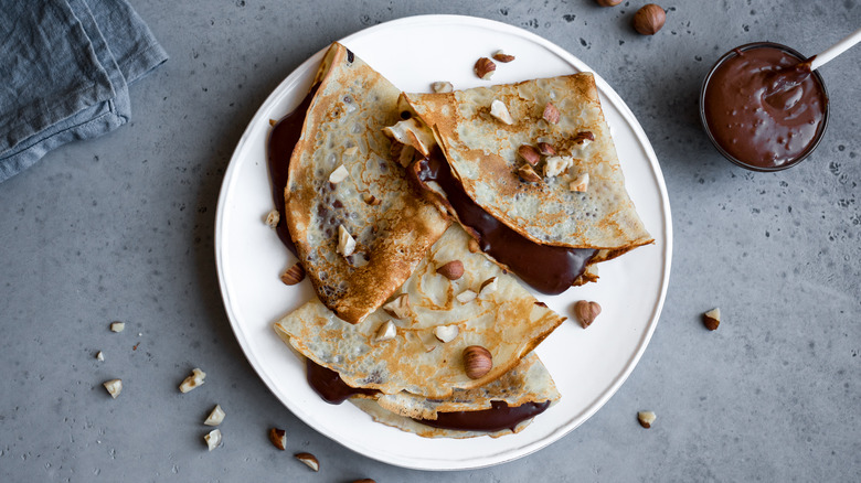 Chocolate crepes on white plate