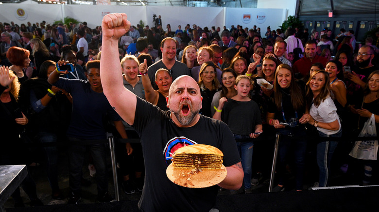 Duff Goldman holding a crepe cake