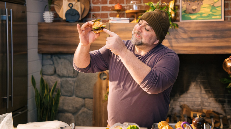 Duff Goldman holding a burger