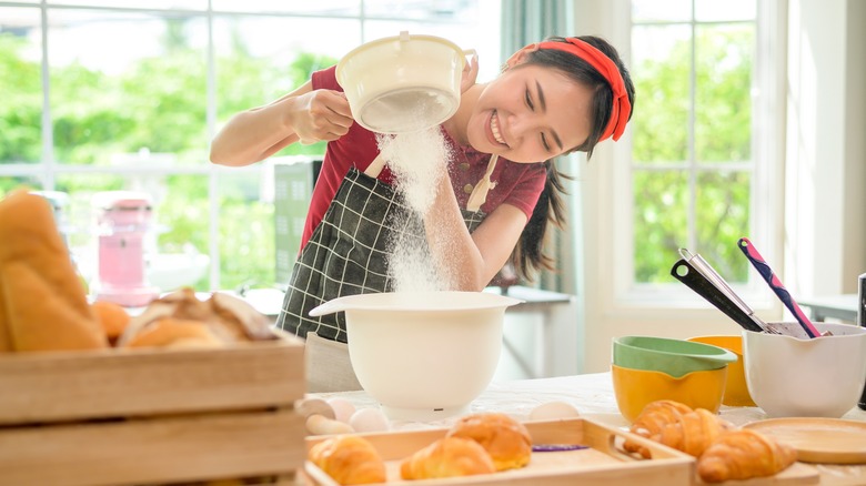 Woman sifts flour