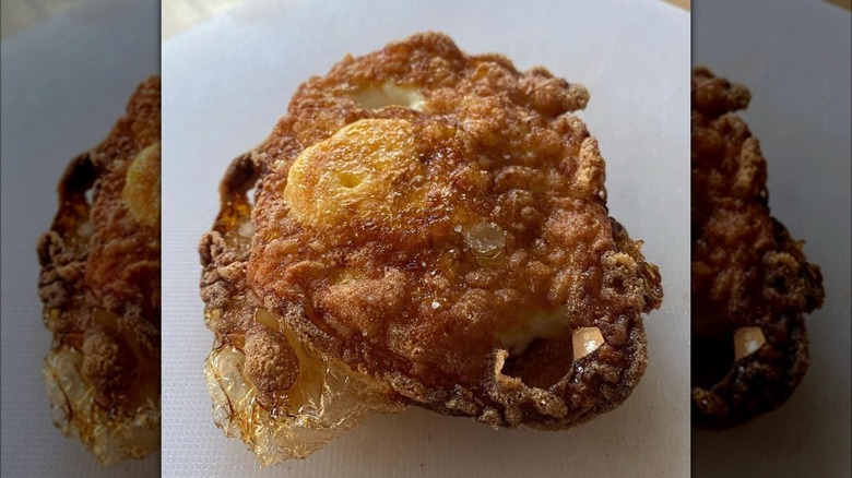 Deep fried egg on white plate