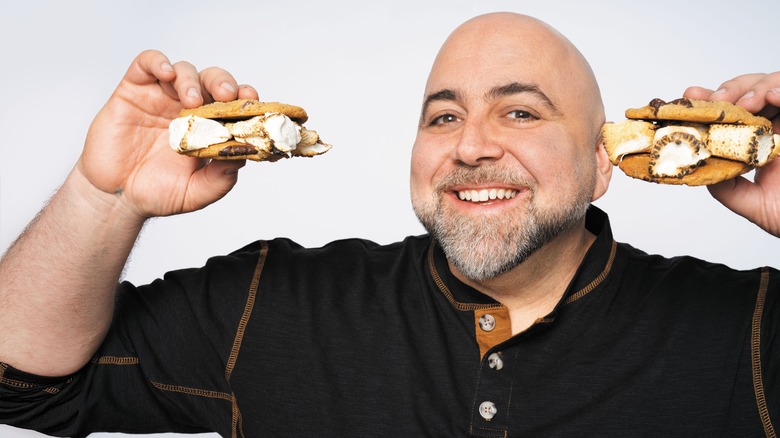 Duff Goldman holding two chocolate chip s'more cookies