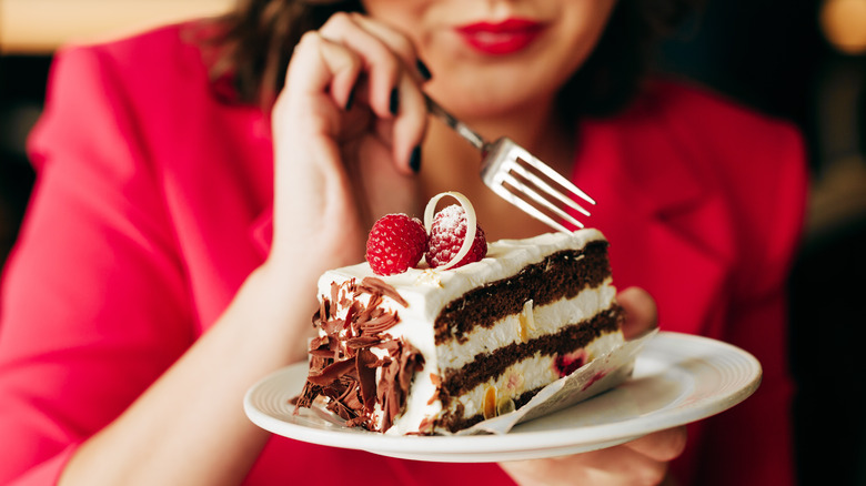 Person eating a cake slice