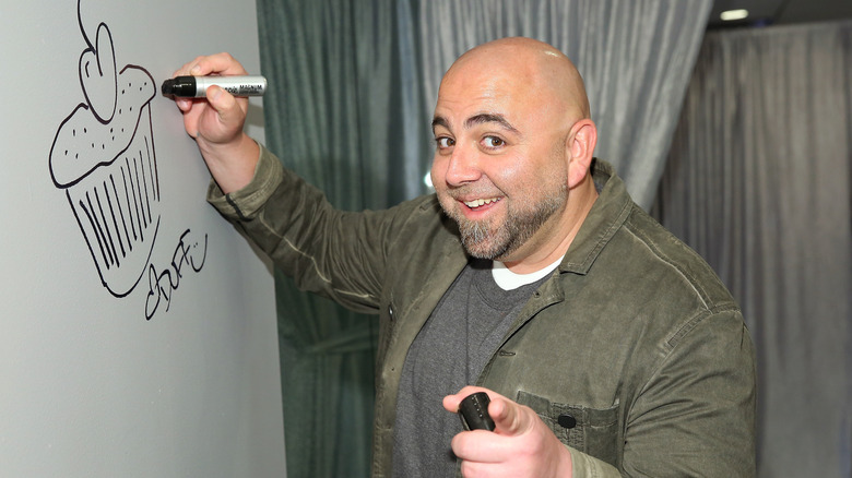 Duff drawing cupcake on whiteboard