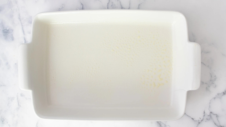 white casserole dish on a white marble-look kitchen counter