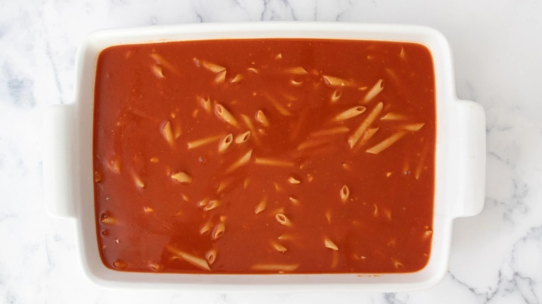 pasta and tomato sauce in a white casserole dish