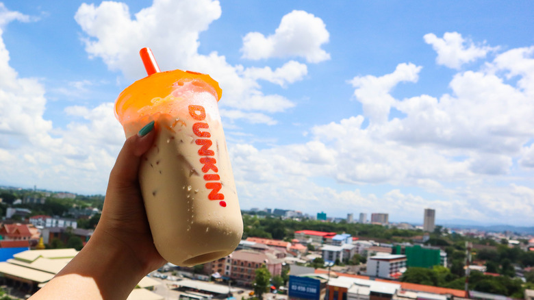 Person holds Dunkin' Donuts Iced Coffee