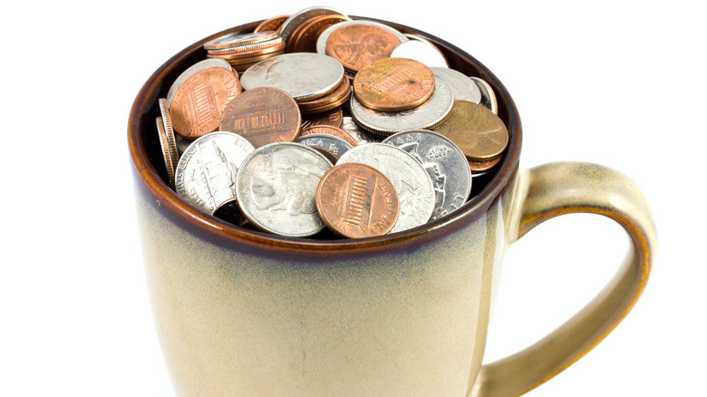 coffee cup filled with change