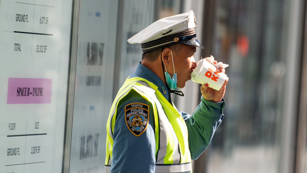 Officer drinking Dunkin' coffee