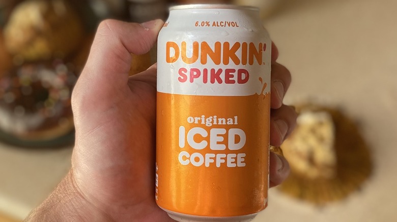 Hand holding spiked coffee can