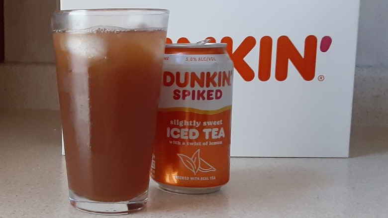 Spiked sweetened iced tea in glass by can