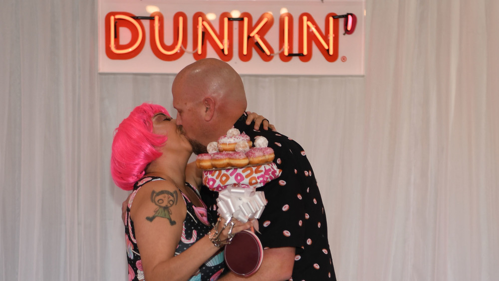 Newlyweds kiss at Dunkin' wedding