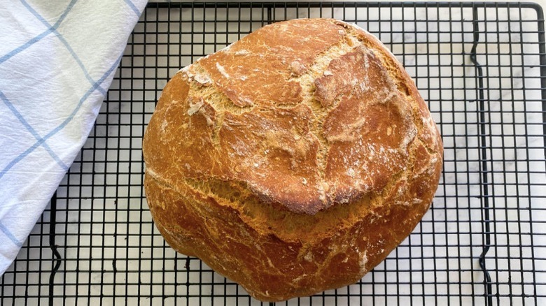 whole wheat bread loaf on cooling rack