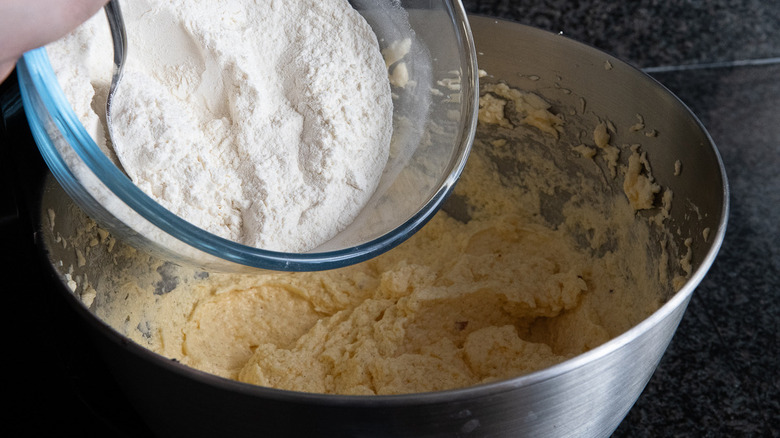 adding flour to batter