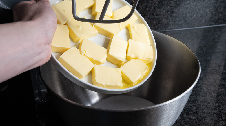 adding butter to mixing bowl