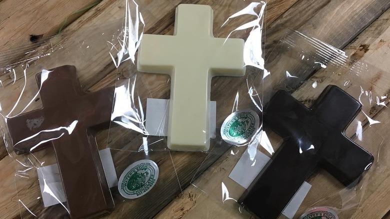 three chocolate cross candies in separate wrappings