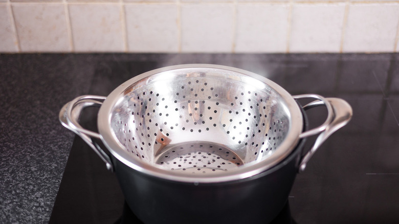 steamer basket on pot on stove