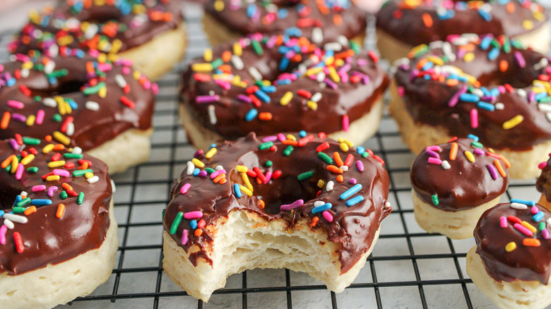 chocolate donuts with sprinkles on cooling rack