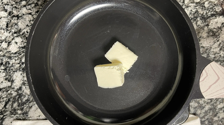 Pats of butter in skillet