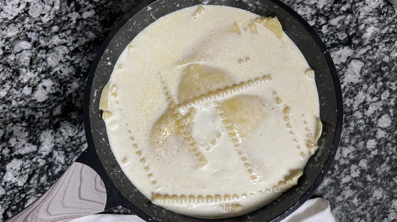 Creamy lasagna noodle dish in skillet