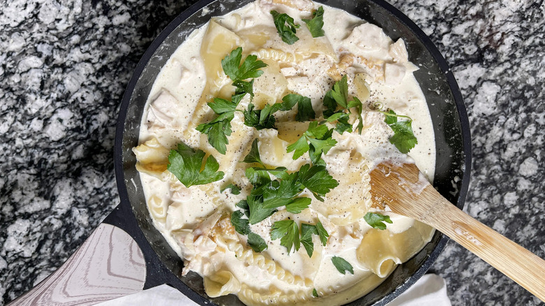 Creamy lasagna skillet garnished with fresh parsley