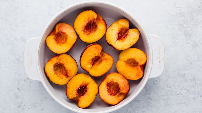 Halved peaches in dish