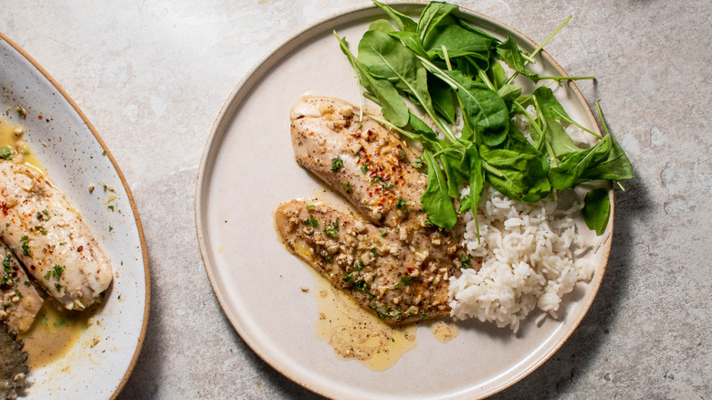 tilapia on plate with greens