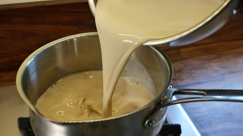 pouring pudding into saucepan