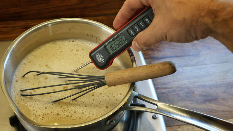 thermometer in saucepan of pudding