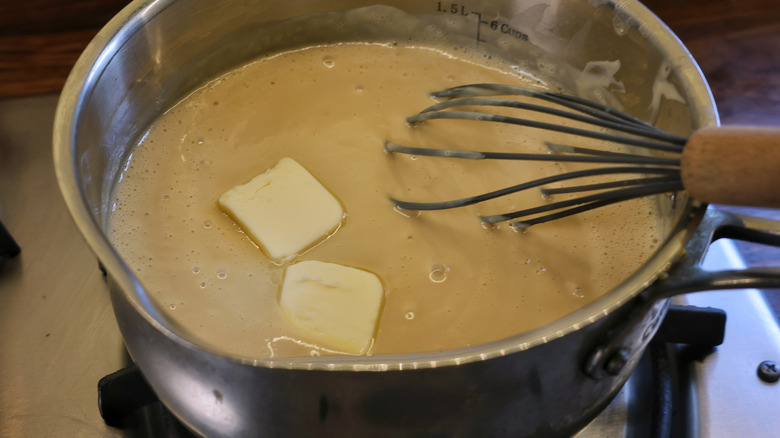 butter melting in saucepan of pudding