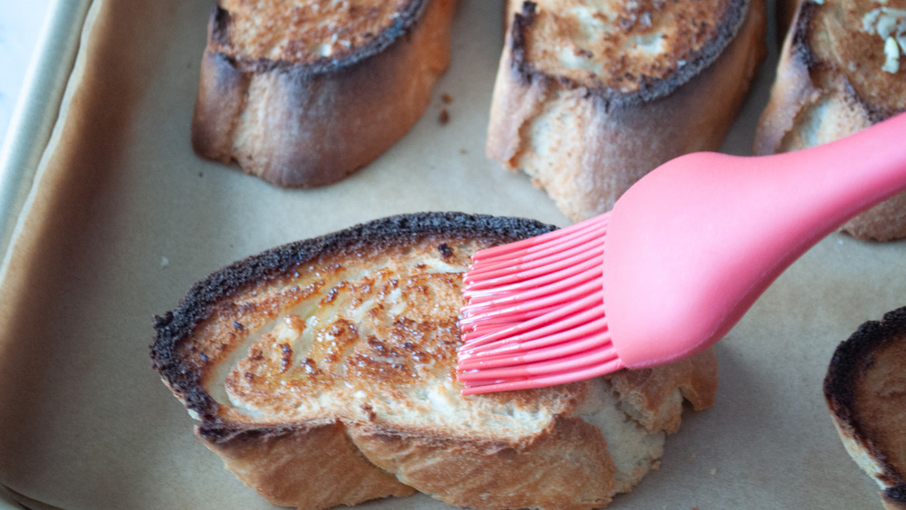 brushing oil on bruschetta