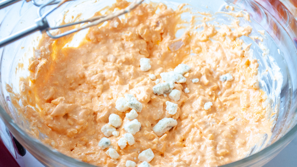 Blue cheese crumbles added into easy buffalo chicken dip